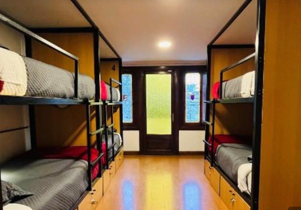 Dormitorio compartido con puerta de vidrieras de colores al jardín